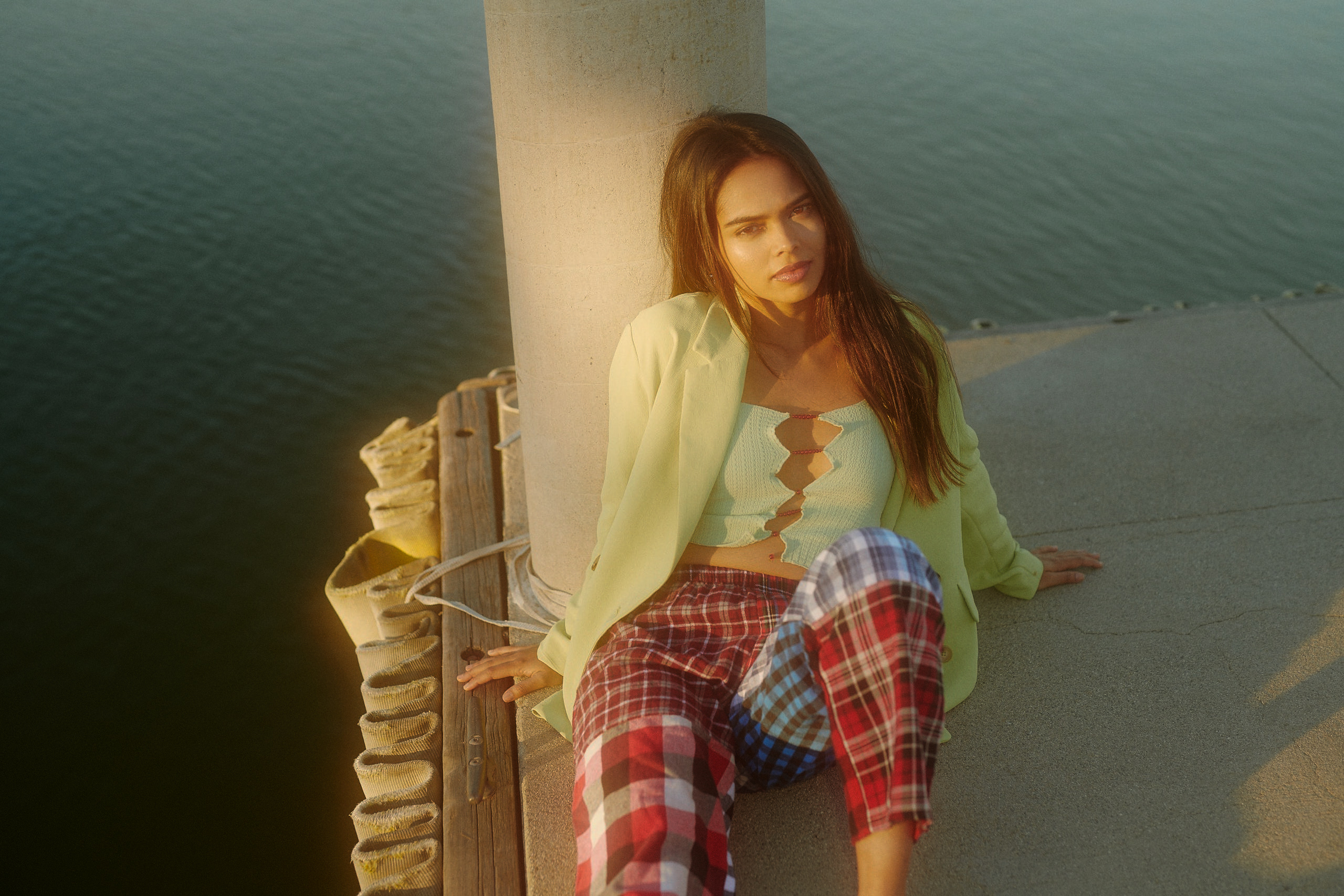 Model Sharmin Rahman sitting on a dock at Santa Fe Recreation Dam wearing Rui and pajama bottom for Flanelle Magazine Editorial