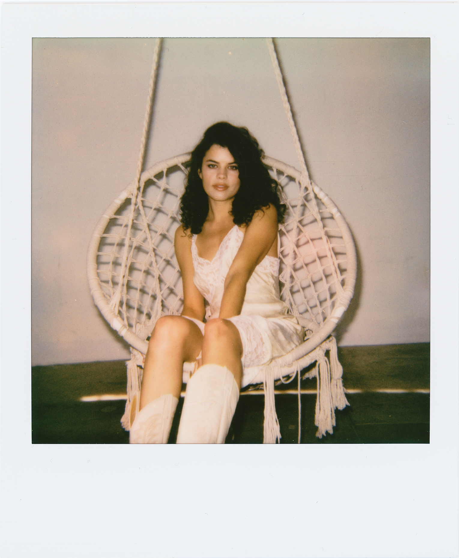 Polaroid of Kalena Audrey  sitting on a bohemian chair