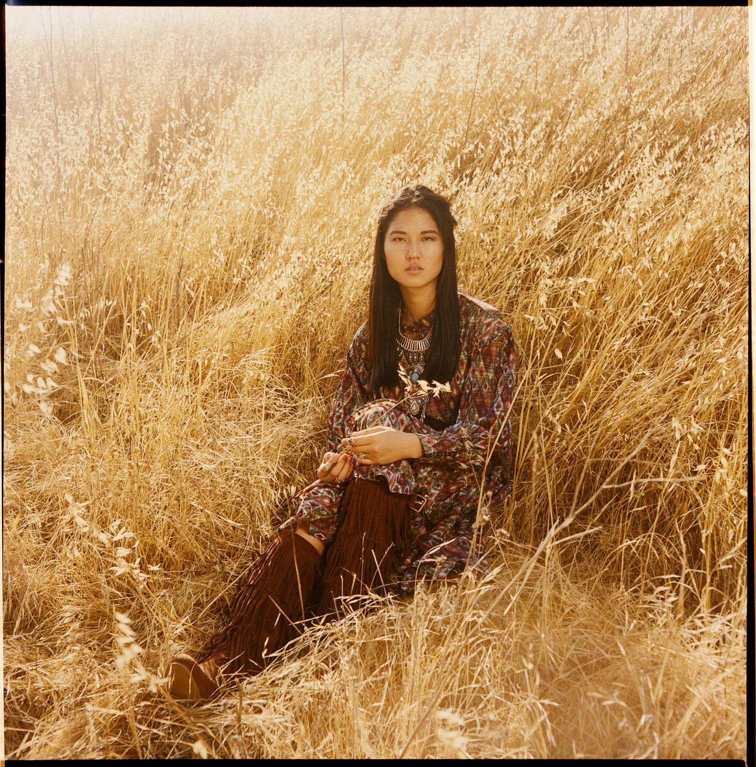 Eunice Chun in a prairie wearing bohemian pattern dress on a sunney day
