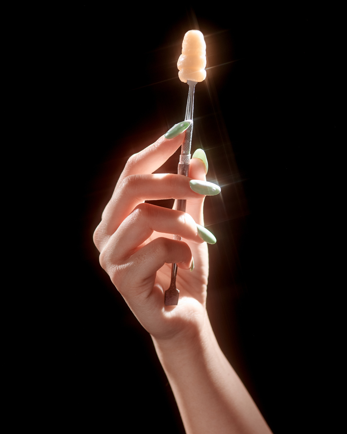 A hand model is holding a cannabis batter 