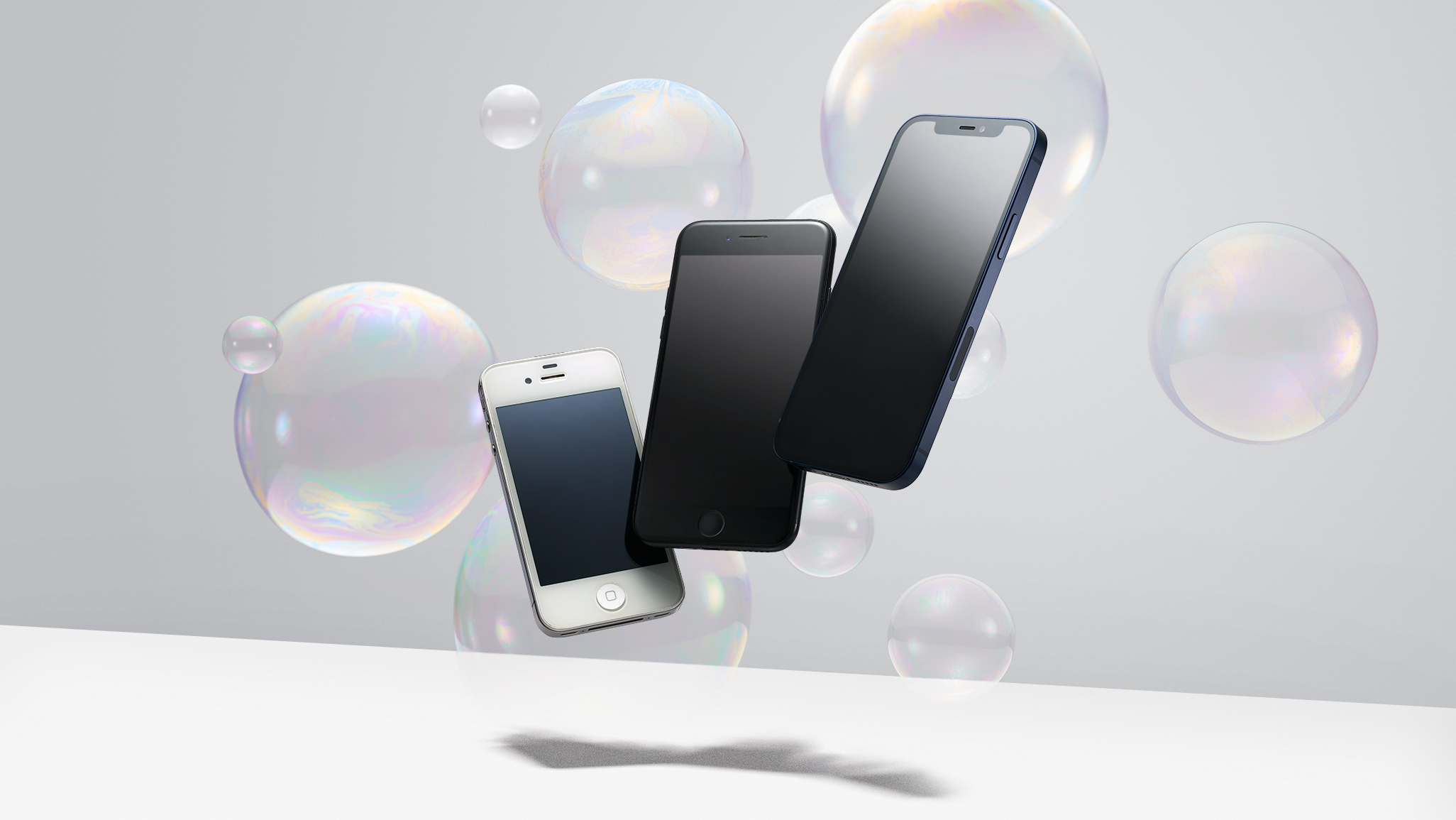 iPhone 3,5, and 8 floating in the air with bubble